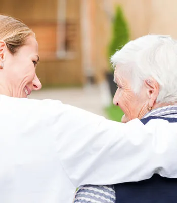 Carer hugging an older woman