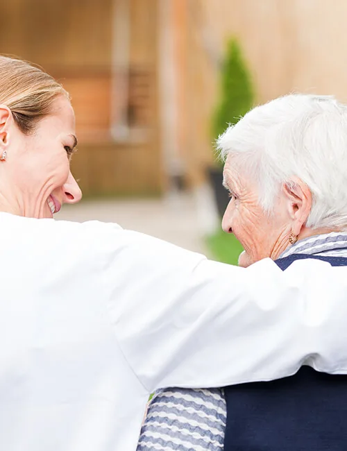 Carer hugging an older woman