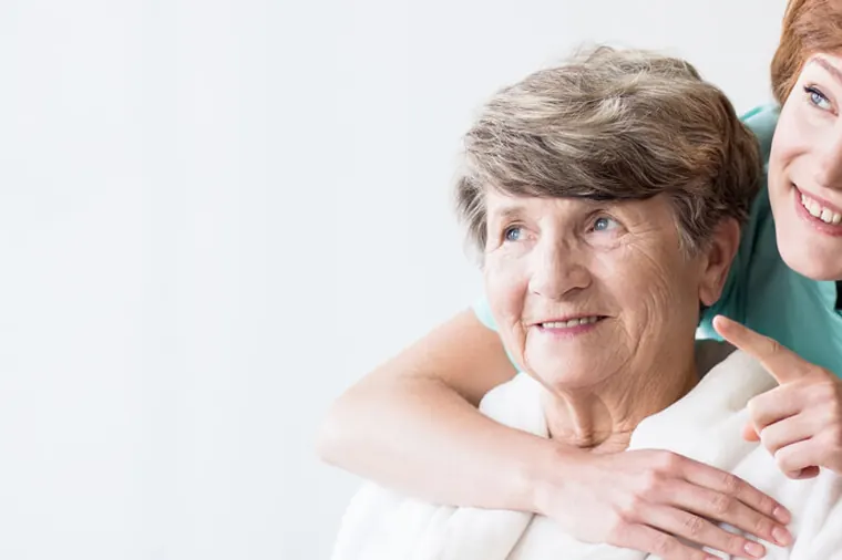 Carer and older woman at home