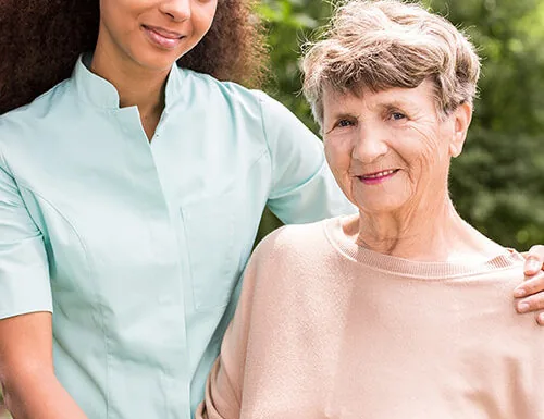 Live-in carer with an older woman in the garden