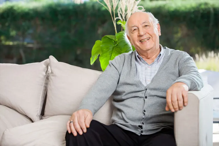 Older man relaxing on the sofa at home