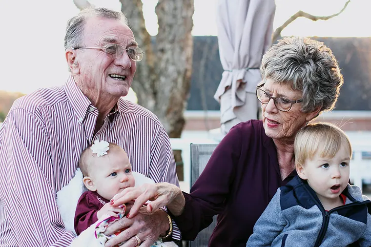 Older couple at home with their grandchildren