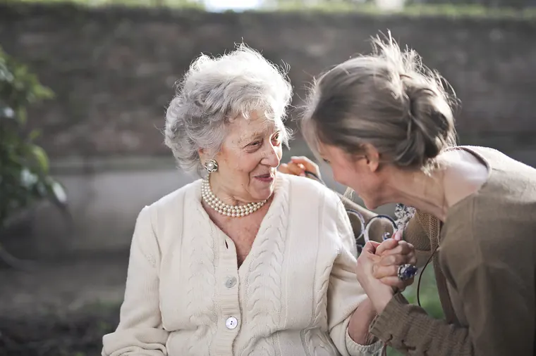 Two older women talking together at home